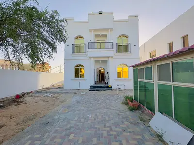Villa for annual rent in Al Muwaihat 1, first occupancy, 6 master bedrooms, 2 majlis (formal sitting rooms), prime location close to all services and