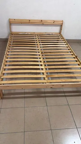 This is an IKEA NEIDEN pine wood bed frame with LÖNSET slatted bed base.