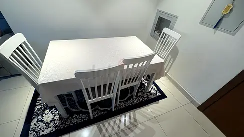 White 4-Seat Dining Table with Chairs and Black Rug - Good Condition