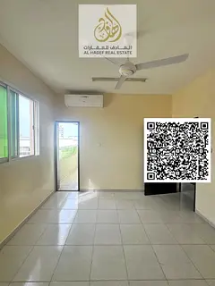 Two-bedroom apartment with a living room in Rawda 1, near Al Hamidiya Police Station. Features a bal