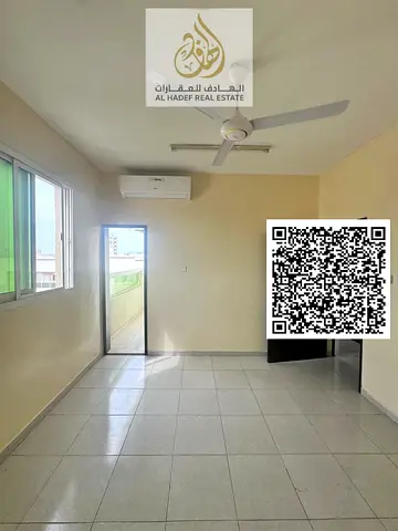 Two-bedroom apartment with a living room in Rawda 1, near Al Hamidiya Police Station. Features a balcony, two bathrooms, and split air conditioning. R
