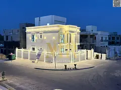 A corner villa for sale in Ajman, two floors and a roof, located on two streets with a large setback