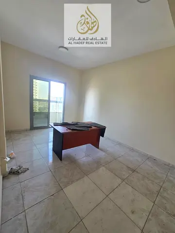 Annual rent in Ajman, Al Nuaimiya 1, near Al Hikma School. The building is for families only. It features a two-bedroom apartment with a living room,