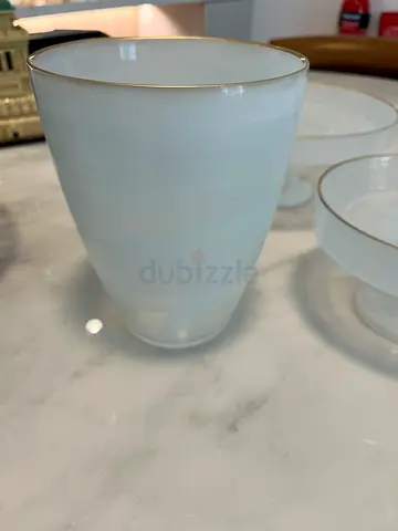 White ceramic cup with gold rim - single piece