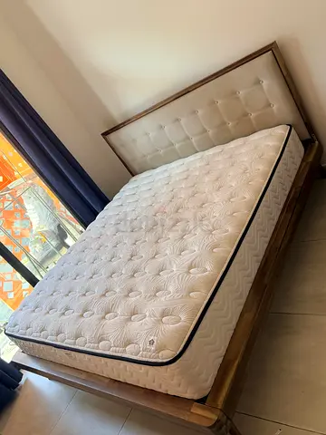 Queen wooden bed frame with upholstered headboard and mattress