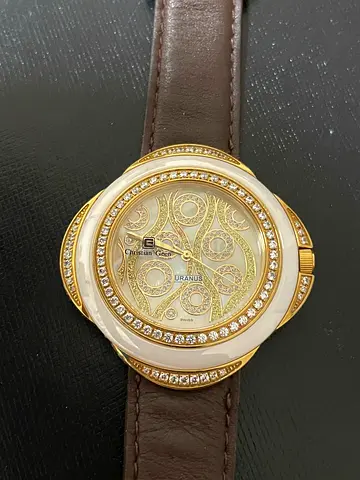 Gold-tone womens fashion watch with crystal bezel and brown leather strap