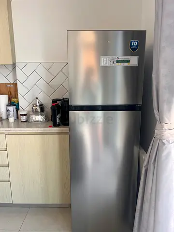 Stainless steel double-door refrigerator in good condition media