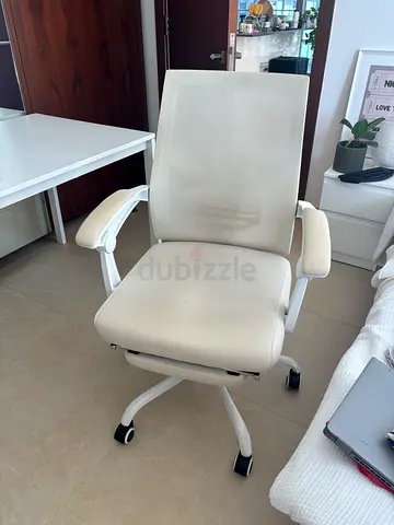 White ergonomic office chair with mesh back and casters