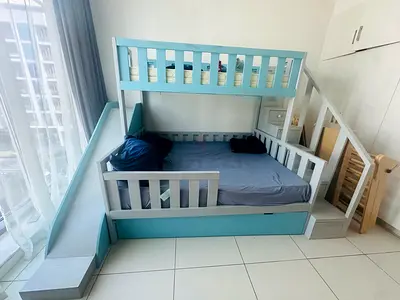 Blue wooden bunk bed with slide and storage — used, good condition. Double size bottom bed