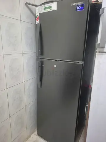 Grey top-freezer refrigerator - good working condition