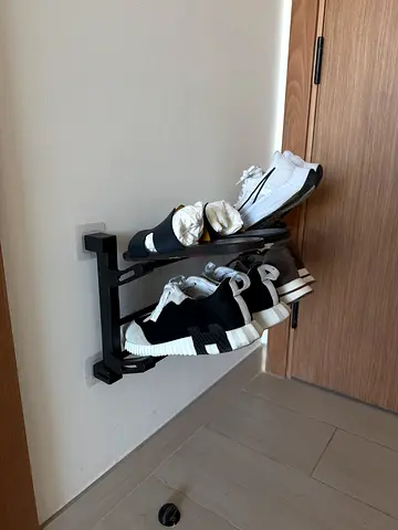 Wall-mounted shoe rack — compact metal organizer, good condition