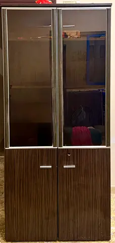 Tall wooden display cabinet with glass doors — good condition