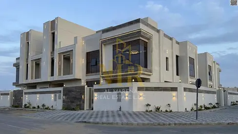 A corner villa for sale in Ajman, two floors and a roof, located on two streets with a large setback in a prime residential location, price includes r