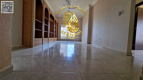 Two-bedroom apartment with a spacious living room for annual rent, including parking and gym access, at a special price.