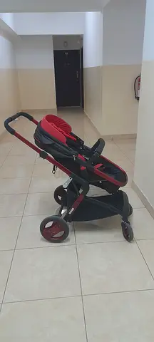 Lightweight red and black baby stroller in good condition