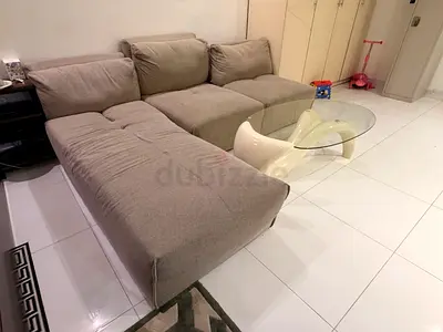 Light grey L-shaped 3-seater fabric sofa with Glass table - good condition