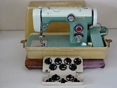 Janome vintage portable sewing machine with accessory bobbins, working condition