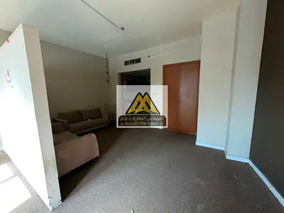 Studio apartment for annual rent in Falcon Towers, Ajman - City View, with ample space and comprehensive parking.