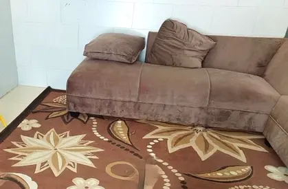 Brown L shaped Sofa with cushion and coffee table good condition