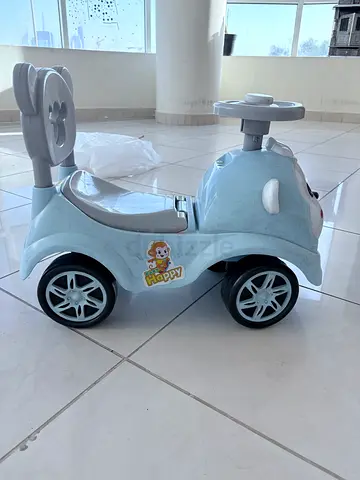 Light blue toddler ride-on push car with handle — good condition