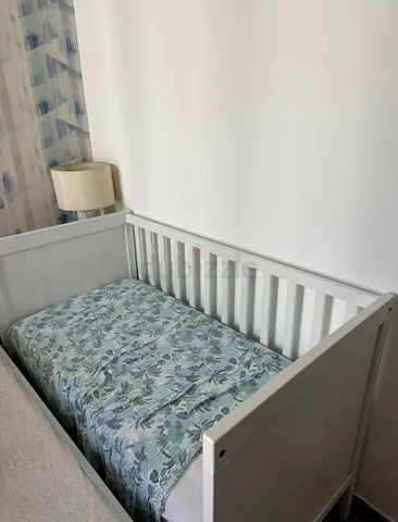White IKEA 120x60 wooden baby crib in good condition. Comes with mattress and cover