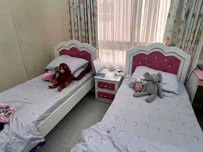 Pair of white and pink twin kids beds with nightstand - good condition