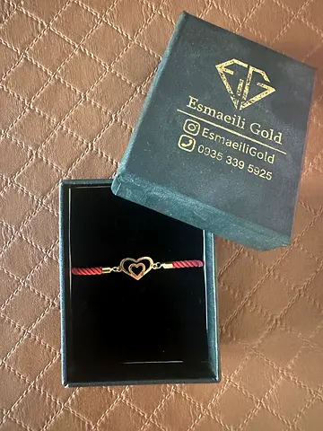 Gold heart charm bracelet on red cord — with box