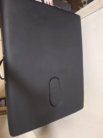 Portable black massage table with face cradle