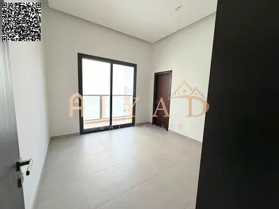 Brand-new 2BR hall in Al Alia: 2 master bedrooms, 3 baths, central AC, balcony, wardrobes, free month, easy Dubai & Sharjah exit.