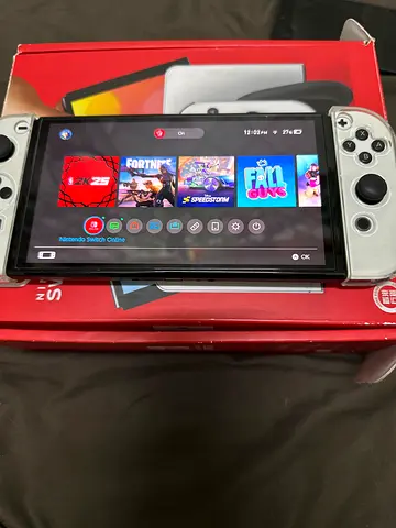 Nintendo Switch OLED with white Joy-Con controllers — good condition