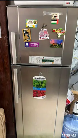 Silver double-door fridge (top freezer) in good working condition