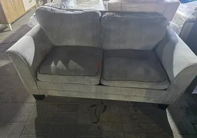 Two-seater grey fabric sofa in good used condition