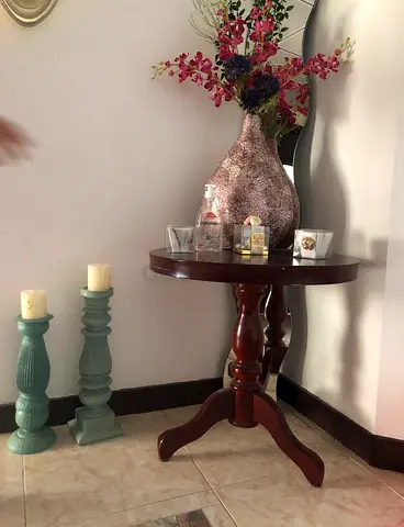 Classic round wooden side table with decorative vase