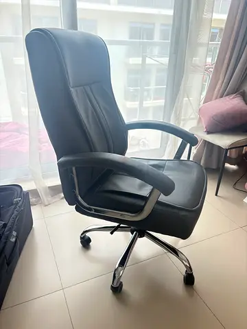 Grey leather executive office chair with armrests and wheels