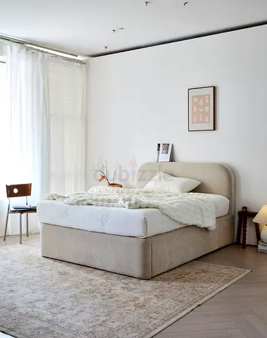 Neutral upholstered double bed with storage base