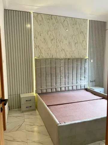 Customize upholstered bed frame with bedside tables and decorative headboard panels