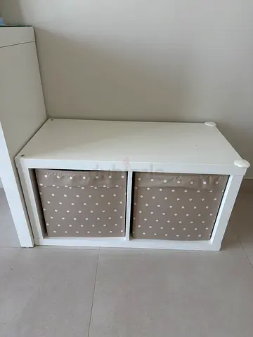 IKEA Kallax white two-cubby storage unit with boxes