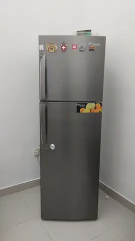 Silver double-door refrigerator in good working condition