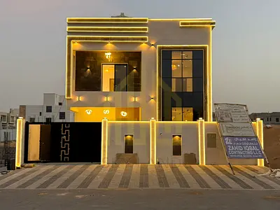 Villa for sale in Ajman, Al Zahia area, including registration fees. It consists of 5 master bedrooms, a majlis (formal sitting room), a living room,