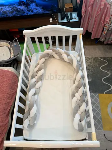 White Baby Crib with Braided Cot Bumper