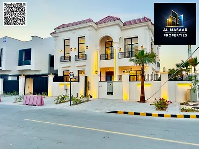 Luxury villa on a corner lot overlooking Al Hamidiya Park, with a private garden and swimming pool – high-end finishes, price includes electricity, wa