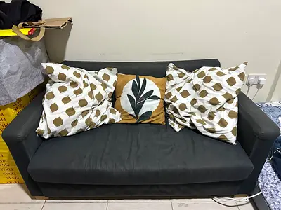 Compact 2-seater dark grey fabric sofa with cushions — good condition (bleach stains on back side)