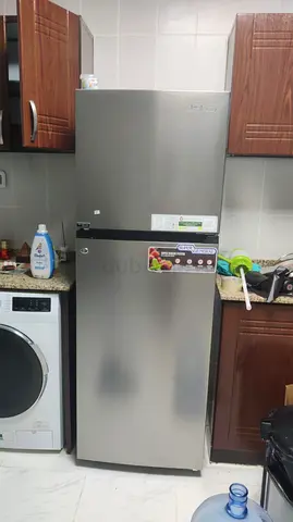 Silver double-door refrigerator in good working condition