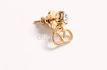 Gold-tone stud earring with crystal and designer logo charm