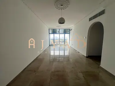 2BR hall for annual rent in Mushrif, Ajman: new tower, private parking, central AC, balcony, hotel-style finishing, easy Dubai & Sharjah exit.