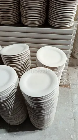 Stack of plain white ceramic dinner plates - bulk