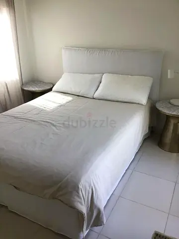 Queen bed frame with padded headboard in off-white (good condition)