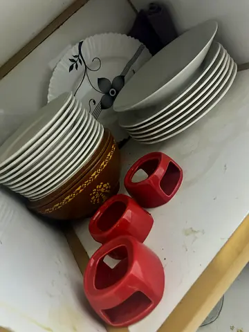 Mixed set of plates and 3 red ceramic napkin holders — good condition