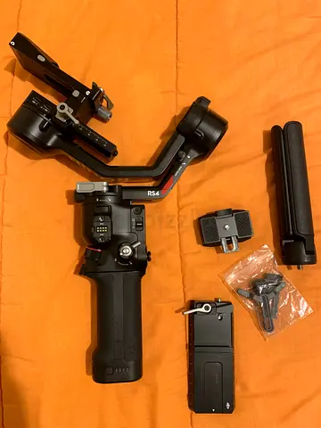 DJI RS 4 GIMBAL WITH SMALLRIG BREIFCASE HANDLE WITH REMOTE CONTROL AND DJI TRACKER ACCESSORY.