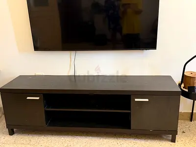 Dark wood TV entertainment unit with storage cabinets